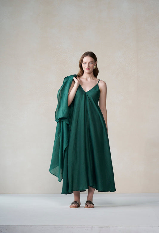 Woman wearing a green dress against a plain background