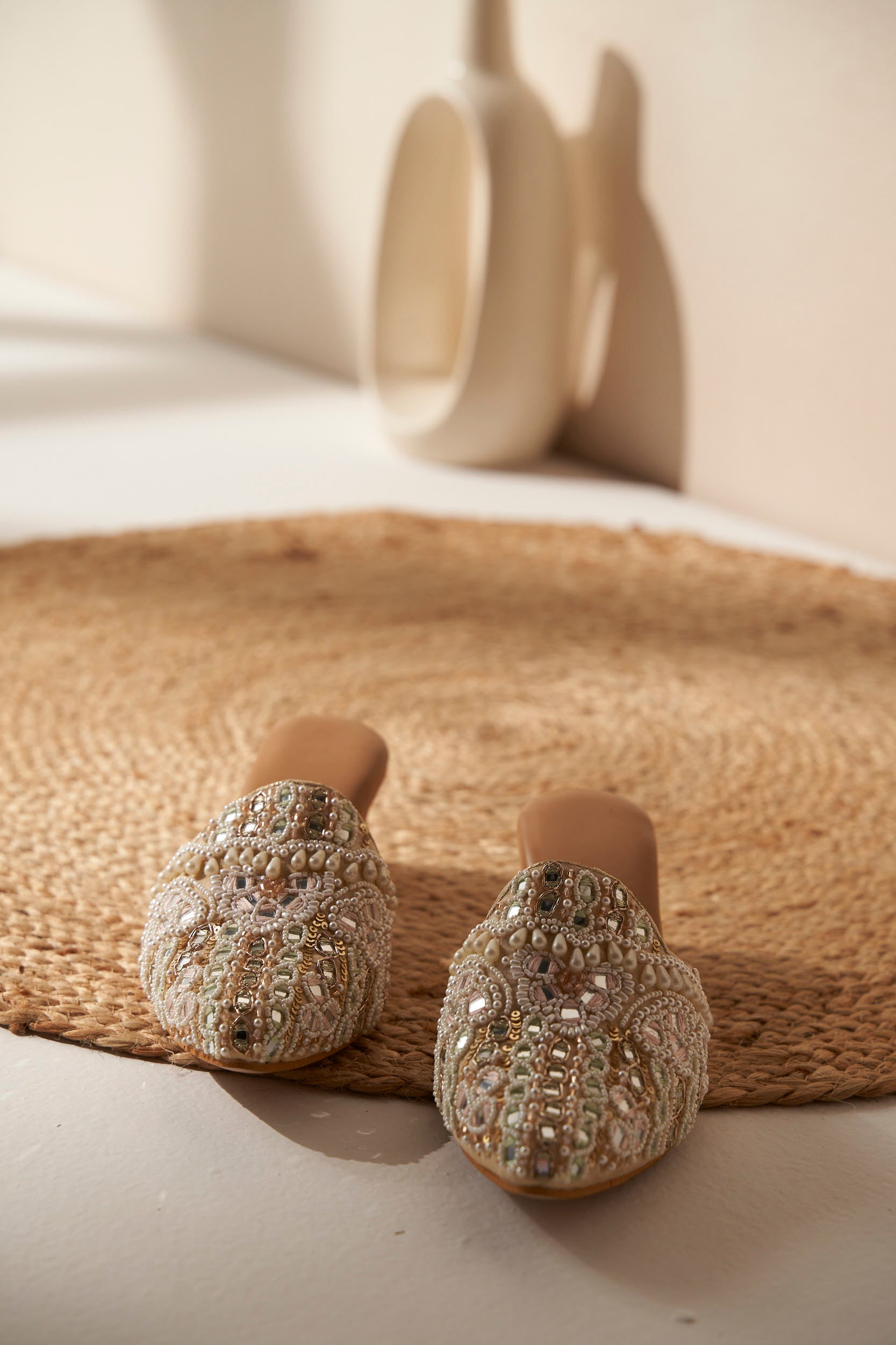 Decorated Indian Mules with beautiful embellishment on a beige mat.  