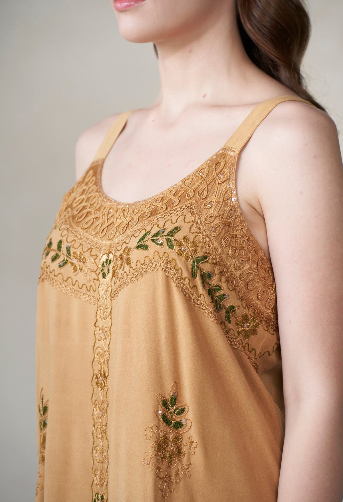 Mustard/Marigold lace top with green embroidery on a neutral background